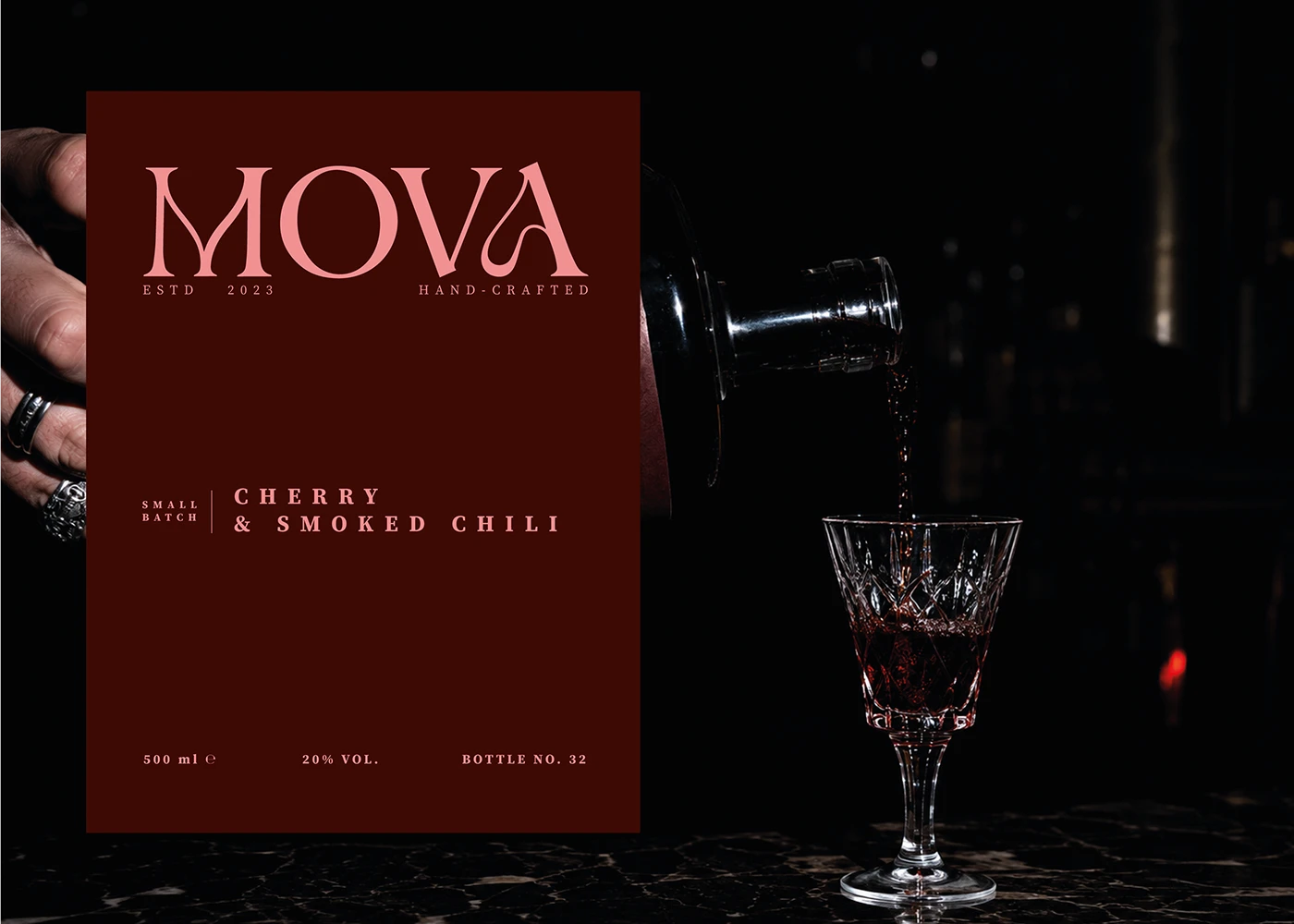 MOVA cherry and smoked chili liqueur label design beside a bottle pouring red liqueur into a crystal glass.