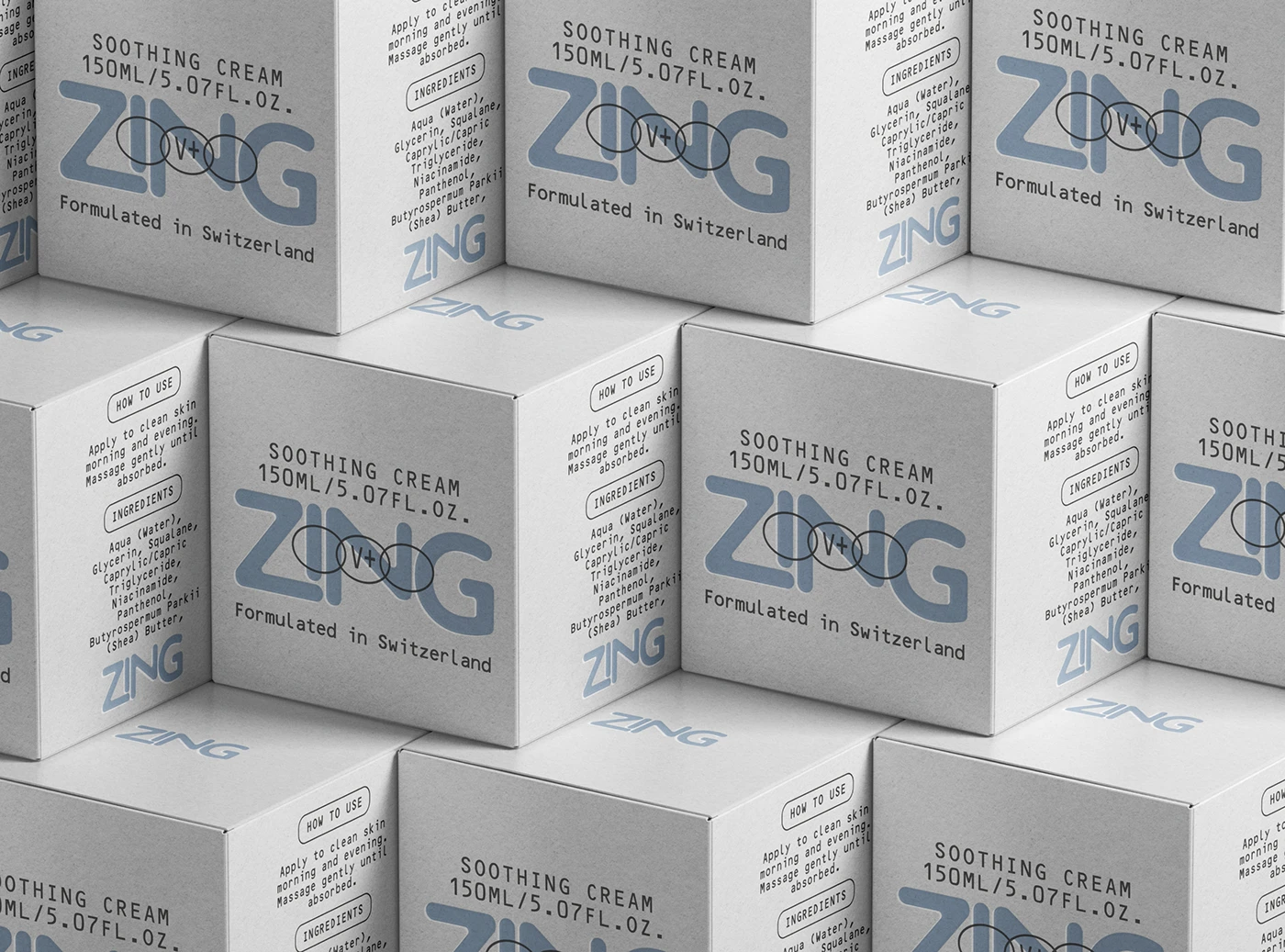 Close-up pattern of ZING soothing cream cartons, showing pale blue logo graphics, minimal black typography, ingredient panels, and textured white packaging.