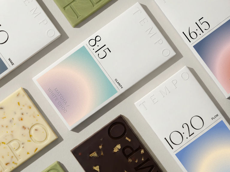 TEMPO chocolate brand identity and packaging design by LYM Design Studio featuring multiple white chocolate bar boxes with time-based labels, soft gradient artwork, embossed typography, and assorted chocolate bars.