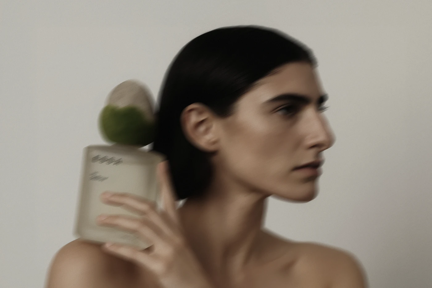 ESSA perfume lifestyle photography featuring model with product — editorial art direction and luxury branding identity for modern perfume packaging.