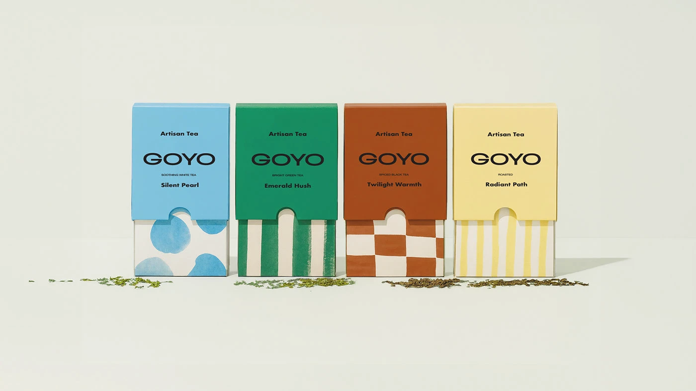 Lineup of Goyo Tea packaging in blue, green, terracotta, and yellow, displayed with loose tea leaves to highlight minimalist brand identity and bold typography