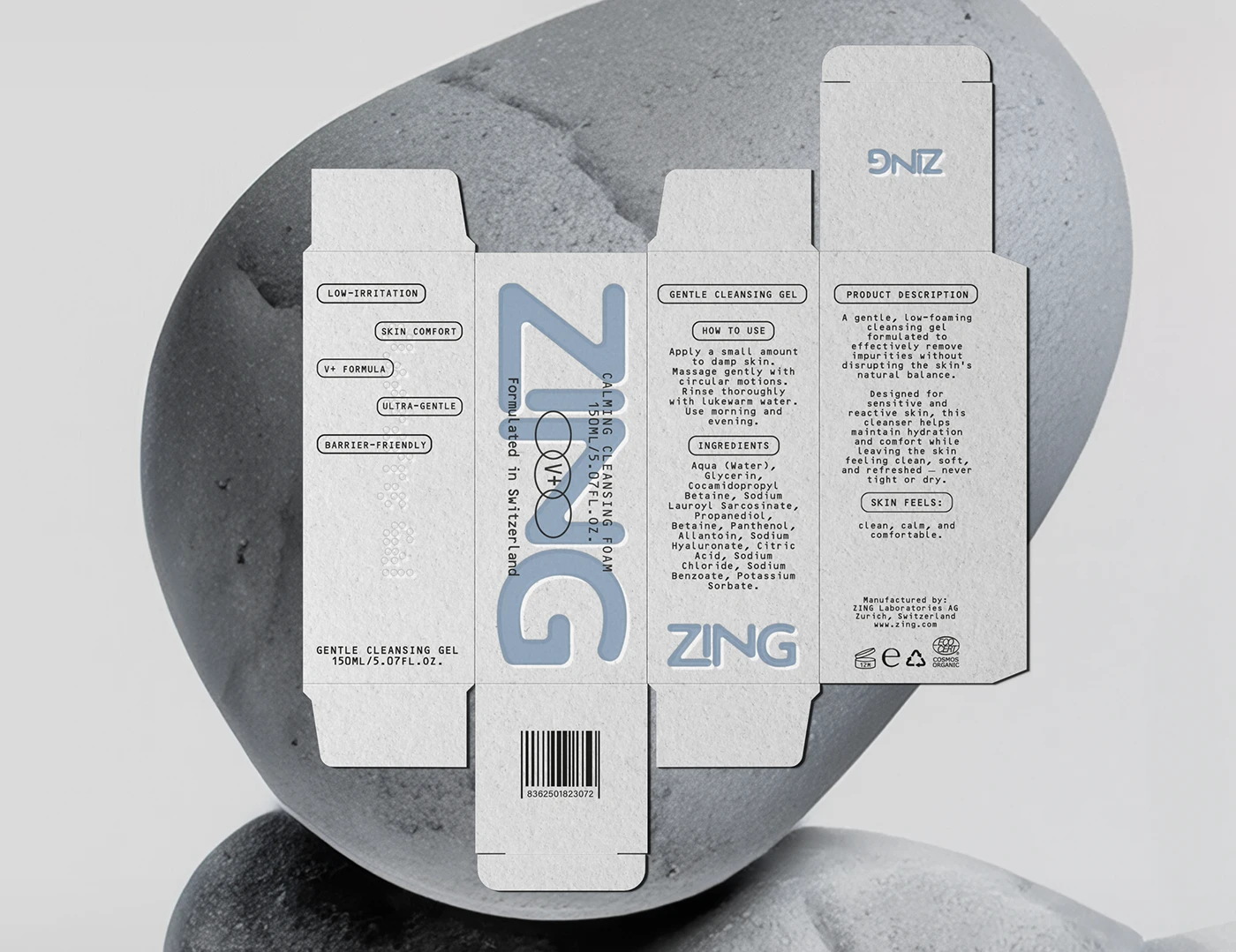 ZING skincare carton dieline placed over smooth gray stones, showing the full packaging layout with product claims, ingredient information, barcode, and soft blue branding.