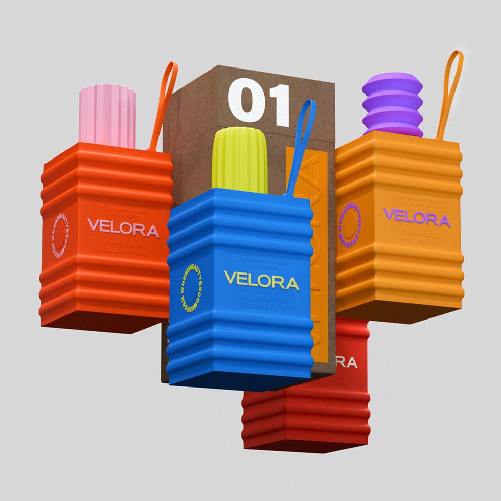 Four Velora sculptural beauty vessels in coral, blue, golden orange, and red are arranged in a suspended composition around a central textured brown box against a light gray background.