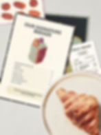 Uncle Dough bakery menu design with illustrated bread graphic and printed receipt next to fresh croissant