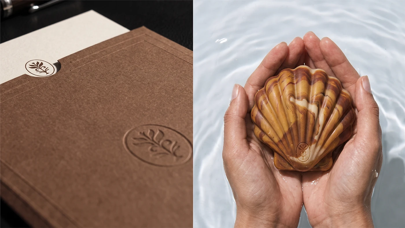 NULA organic soap branding featuring embossed brown packaging alongside a marbled shell-shaped soap held over water.