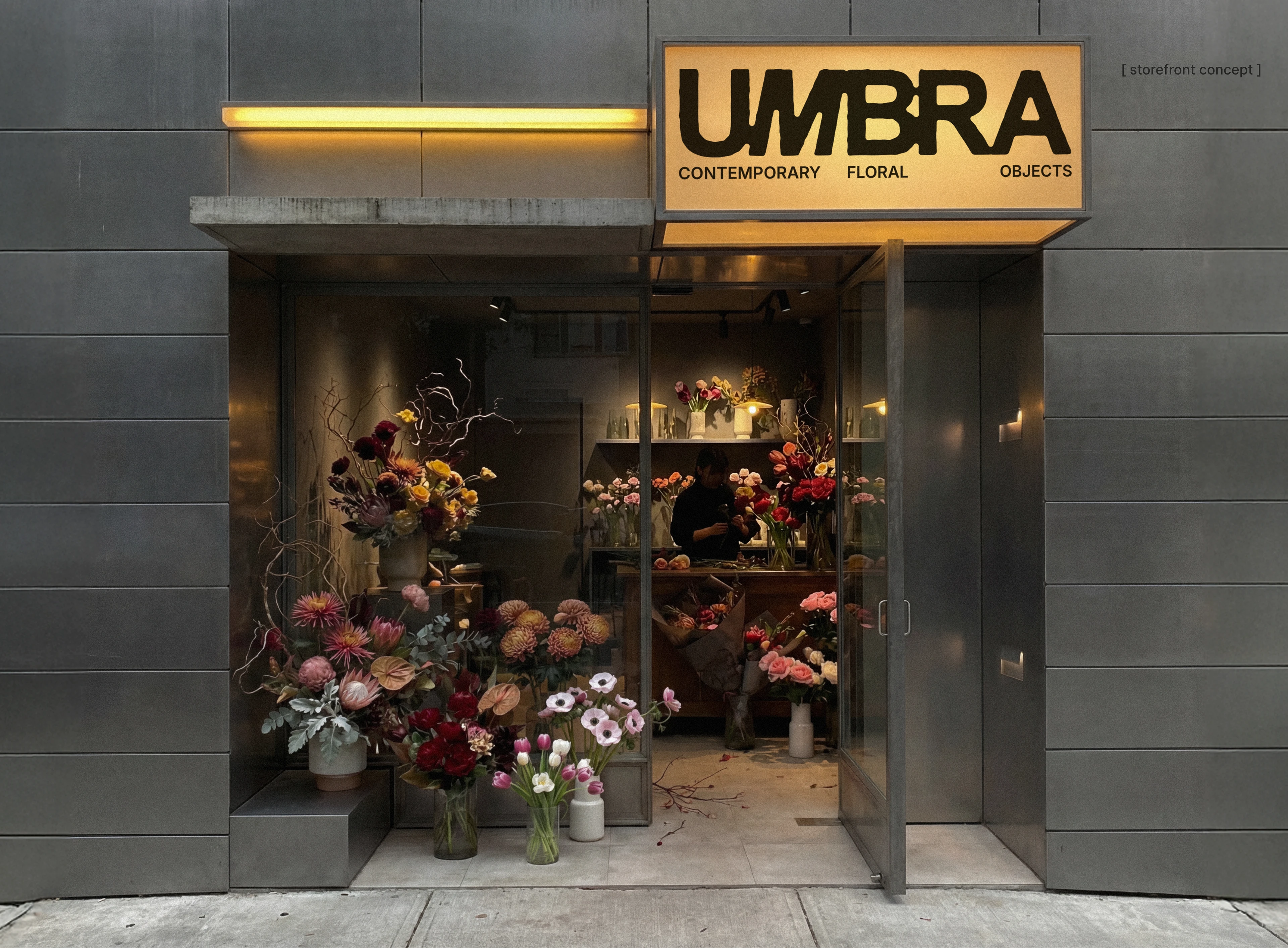 UMBRA floral brand identity storefront concept with a glowing yellow sign, concrete exterior, glass entry, and colorful floral arrangements displayed inside and outside the shop.