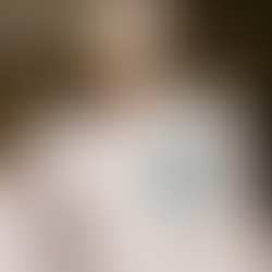 Back of a white t-shirt featuring a large teal pixelated grape icon and the Catalyst Wine Bar logo.