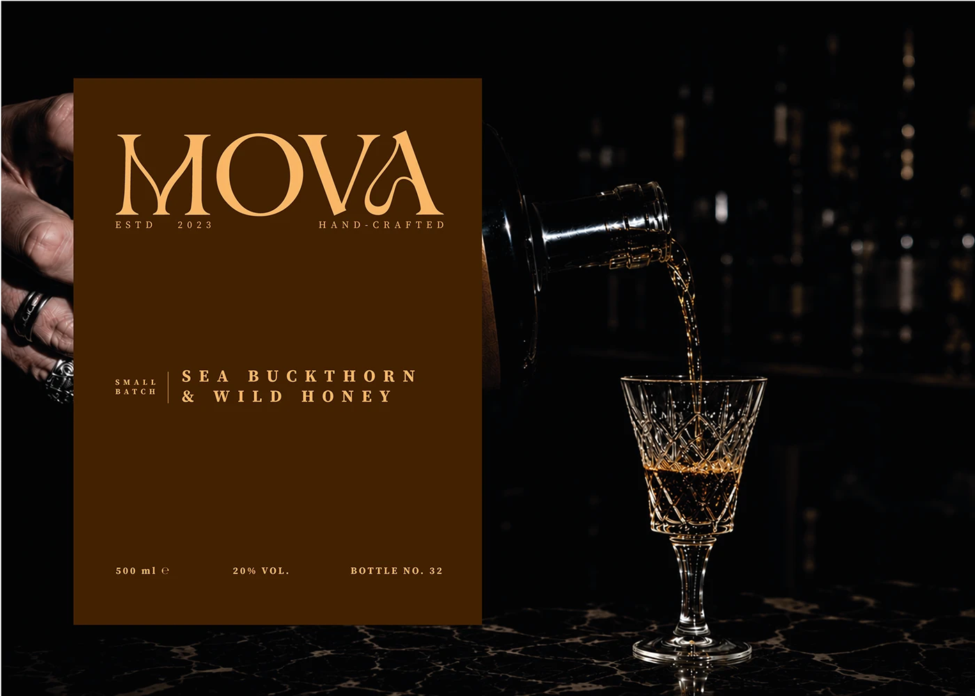 MOVA sea buckthorn and wild honey liqueur label beside a bottle pouring into a crystal glass.