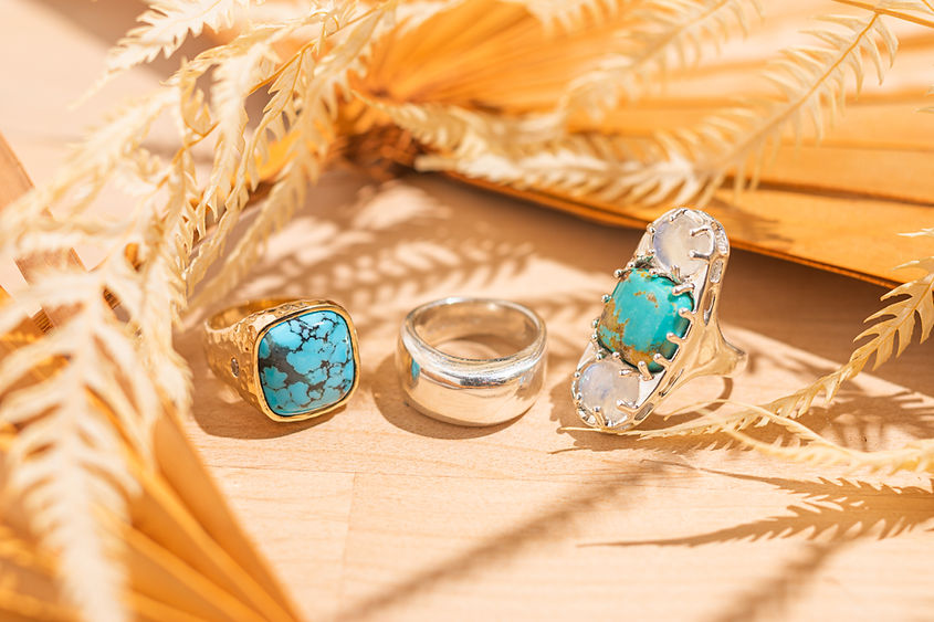 lelamooi rings on wood table with brown fern leaves