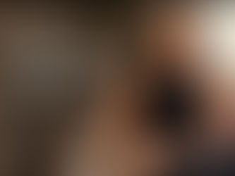 Black woman with long braids sitting indoors holding a mug in a calm, softly lit space, with the title “Why We Hide When We Hurt and Why Opening Up Helps Us Heal” overlaid on the image.