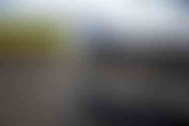 A close up of the front of a Tesla Model S in front of a farm field, By Jeff B Photography