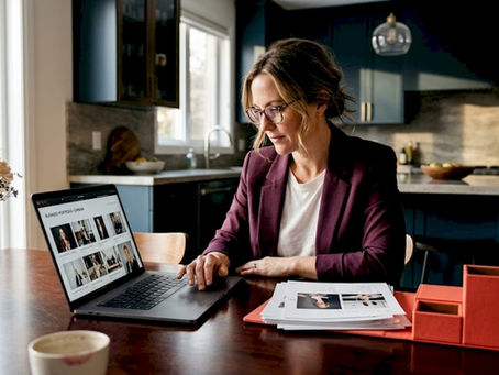 Business owner reviewing photo gallery on laptop