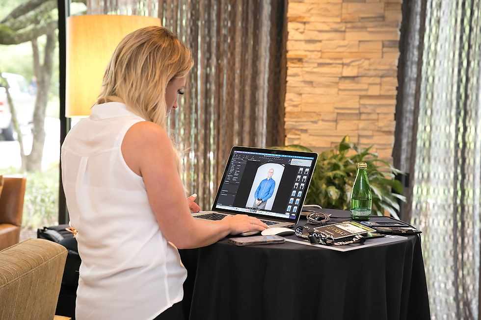 A woman using a laptop to manage images from a photo session.