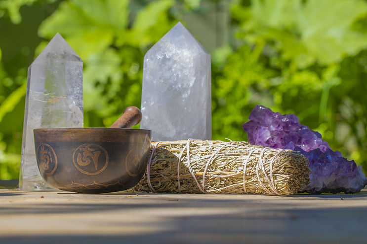 Crystals, smudge stick, and singing bowl to represent energetic healing in Hawaii.