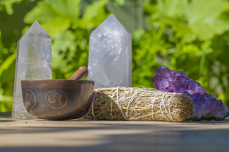 Crystals, smudge stick, and singing bowl to represent energetic healing in Hawaii.