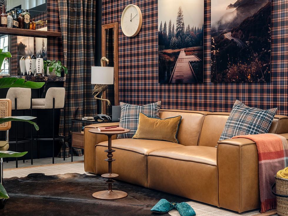Sitting area with plaid walls and leather sofa.