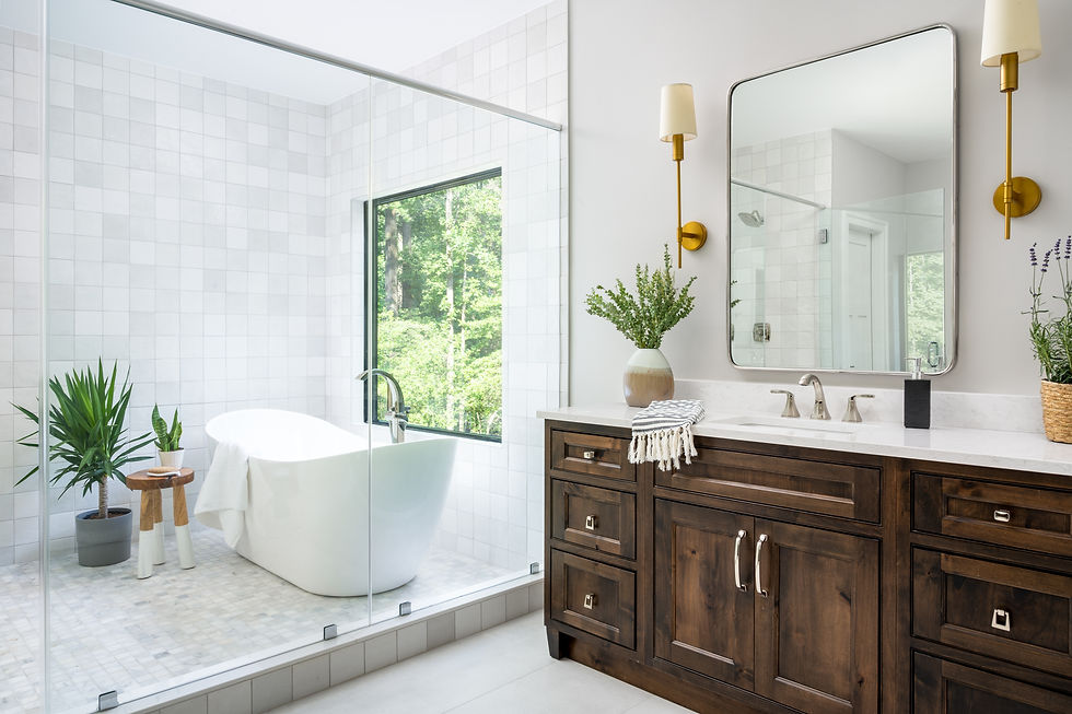 Primary bathroom with wood vanity and tub in shower combination.