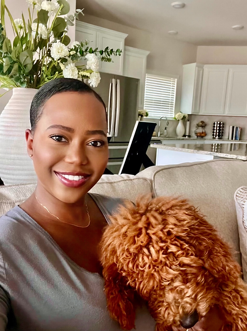 A young woman sitting on a couch with a puppy.