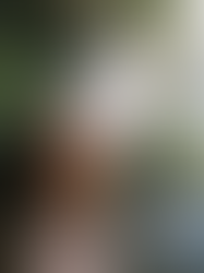 Woman enjoying facial steam in a plant-filled room, practicing calming self-care and supporting emotional healing and relaxation.