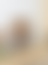 Overwhelmed woman experiencing warning signs of burnout in women, holding her head while sitting at a desk with a laptop