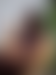 Wellness coach sitting in a cozy chair reading and unwinding as part of a realistic self-care evening routine for busy women.