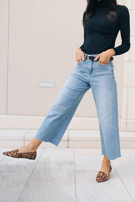Woman wearing blue jean wide leg pants with leopard shoes