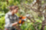 Woman using a mini chainsaw at Toad Hall Garden Machinery in Henley