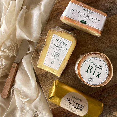 A selection of Cheese on a wooden chopping board
