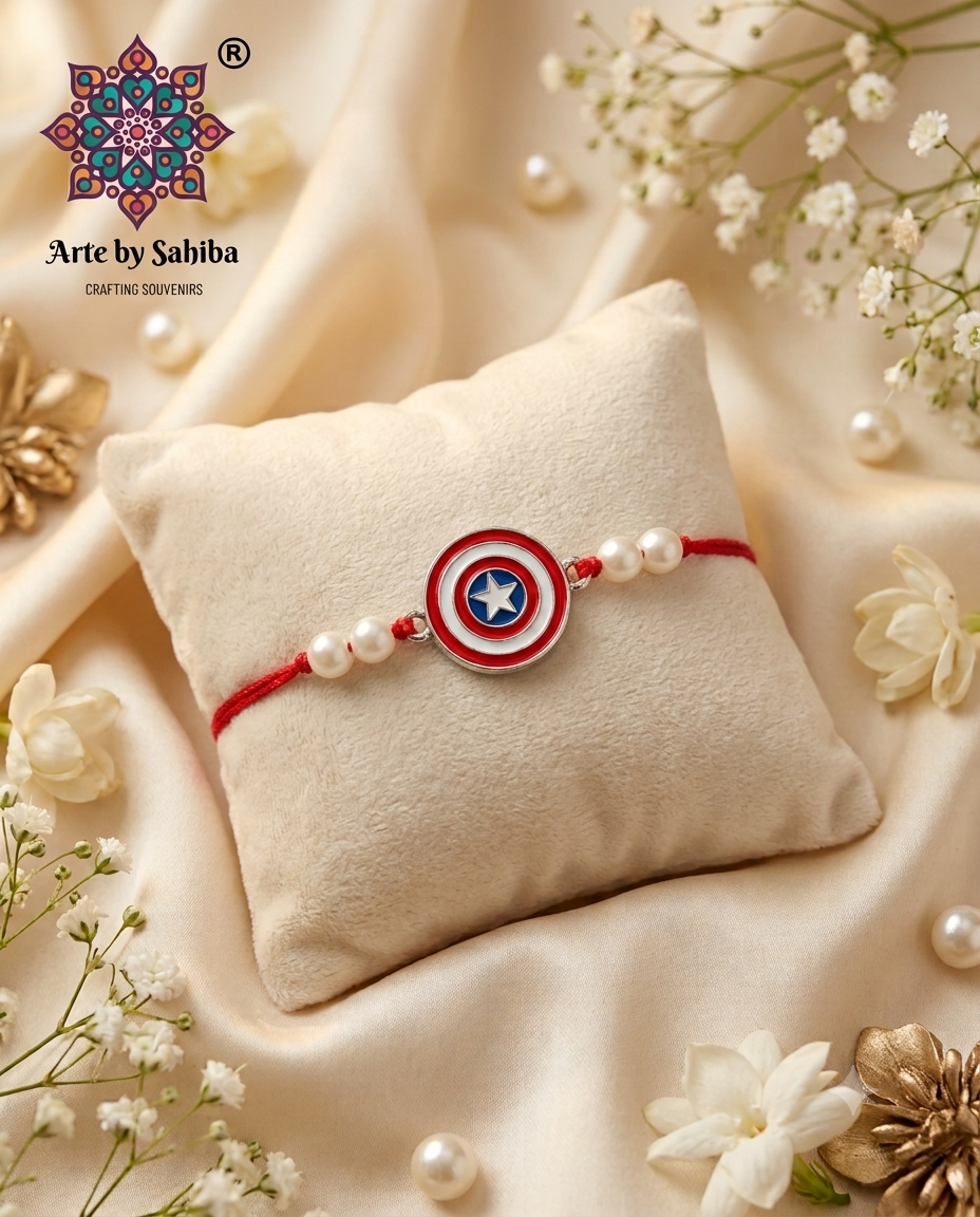 Miniature red, white, and blue Captain America shield character Rakhi accented with white pearls and a red tying thread on a