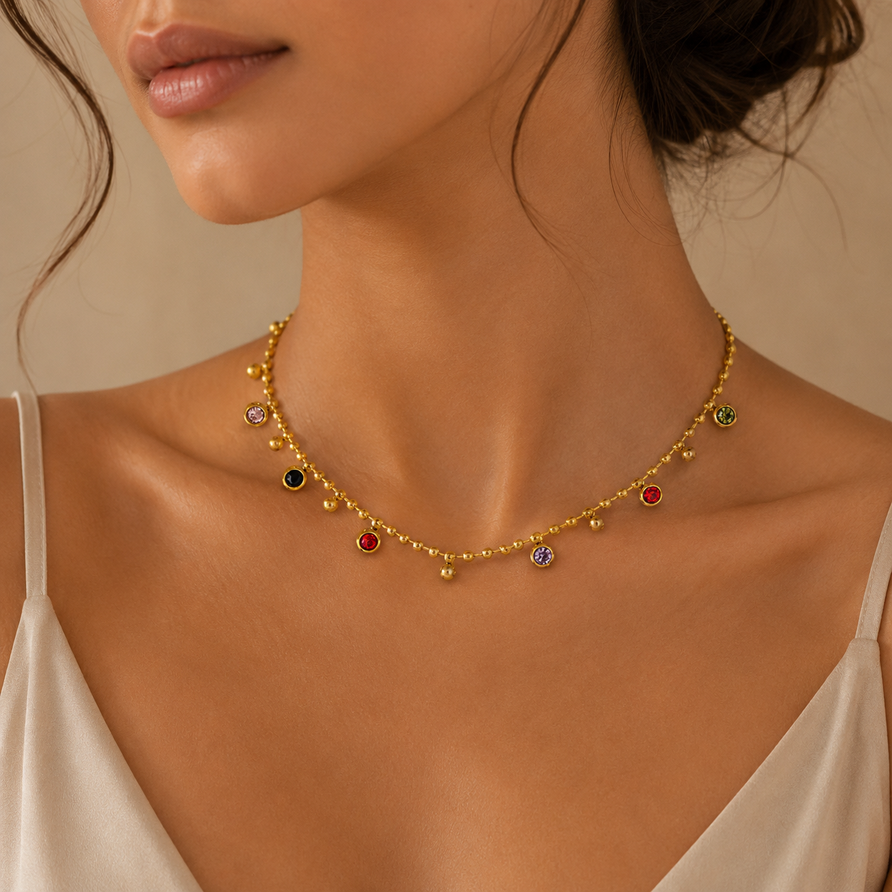 Model wearing Jewel Bloom Necklace featuring multicolour crystal charms on a gold beaded chain in luxury styling
