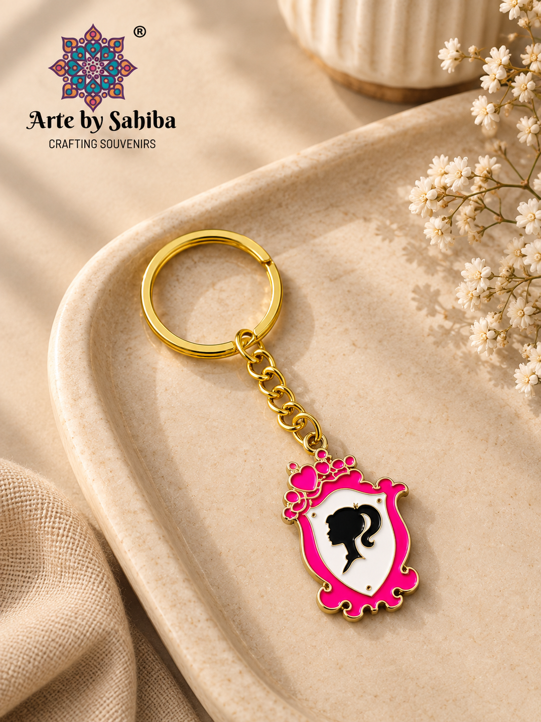 Barbie enamel keychain with black ponytail silhouette profile and gold chain