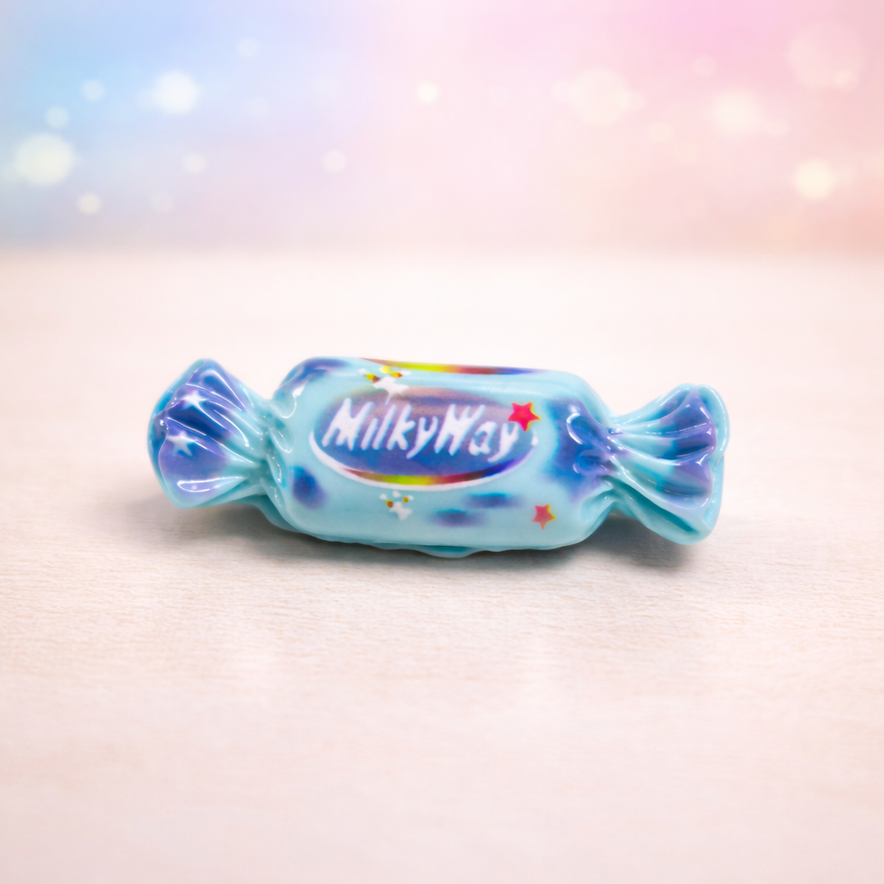 Milky Way candy fridge magnet miniature with glossy blue wrapper design on soft pastel background