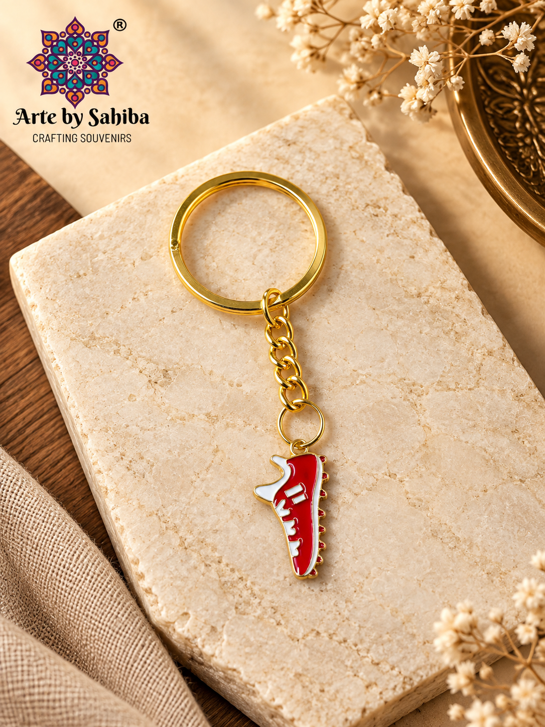 Red and white sneaker enamel metal keychain on a gold chain