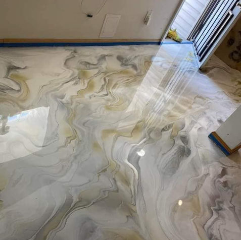 Swirling epoxy flooring in white, gold, and gray colors; TILES & FLOORING; reflective surface