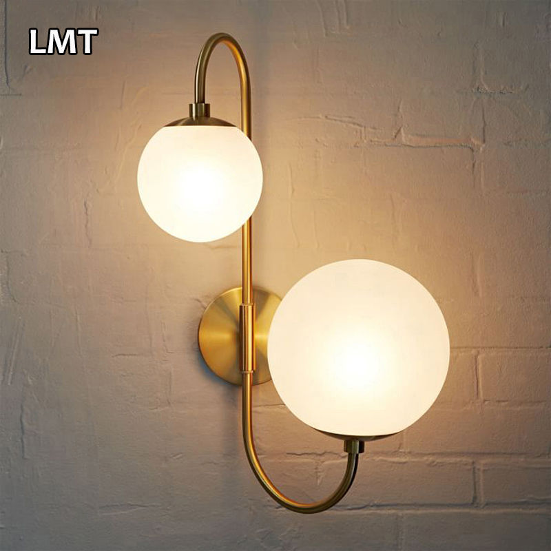 Thumbnail: Modern wall light fixture with two frosted globes, LMT on brick wall.