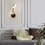 Thumbnail: Bird-shaped wall sconce, above a sofa with pillows, elegant home interior design.