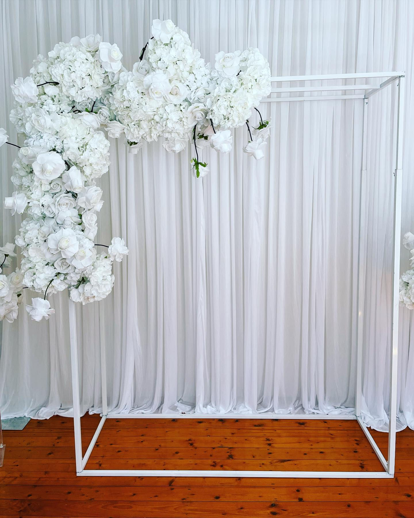 White arch with side flowers 