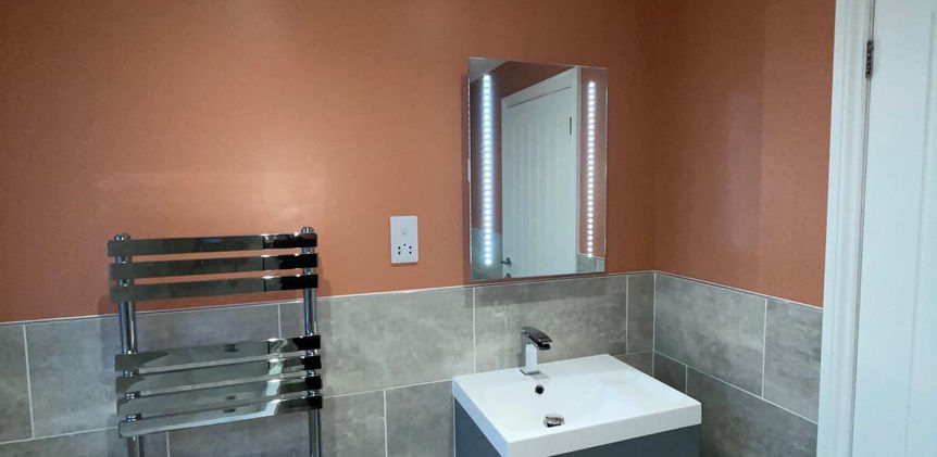 Sink and radiator with orange wall behind