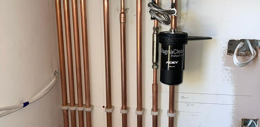 Close up of boiler and pipework beneath