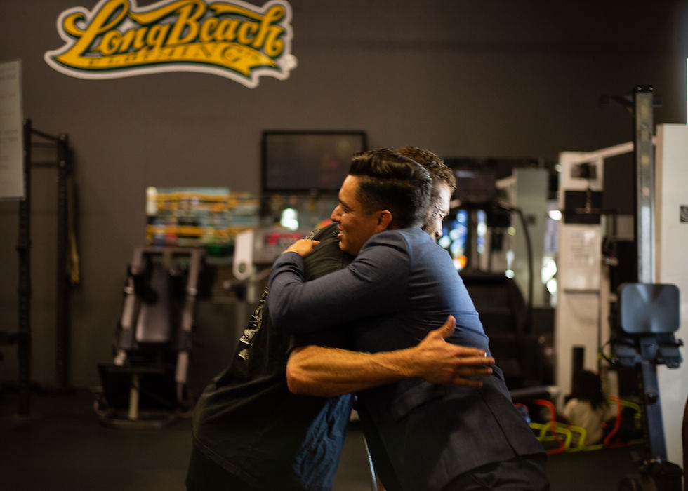 Chris Sweeney hugging a business owner