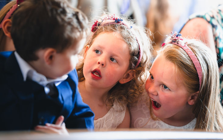 The bride and groom’s children at the wedding ceremony, standing together and adding a heart warming moment to the day
