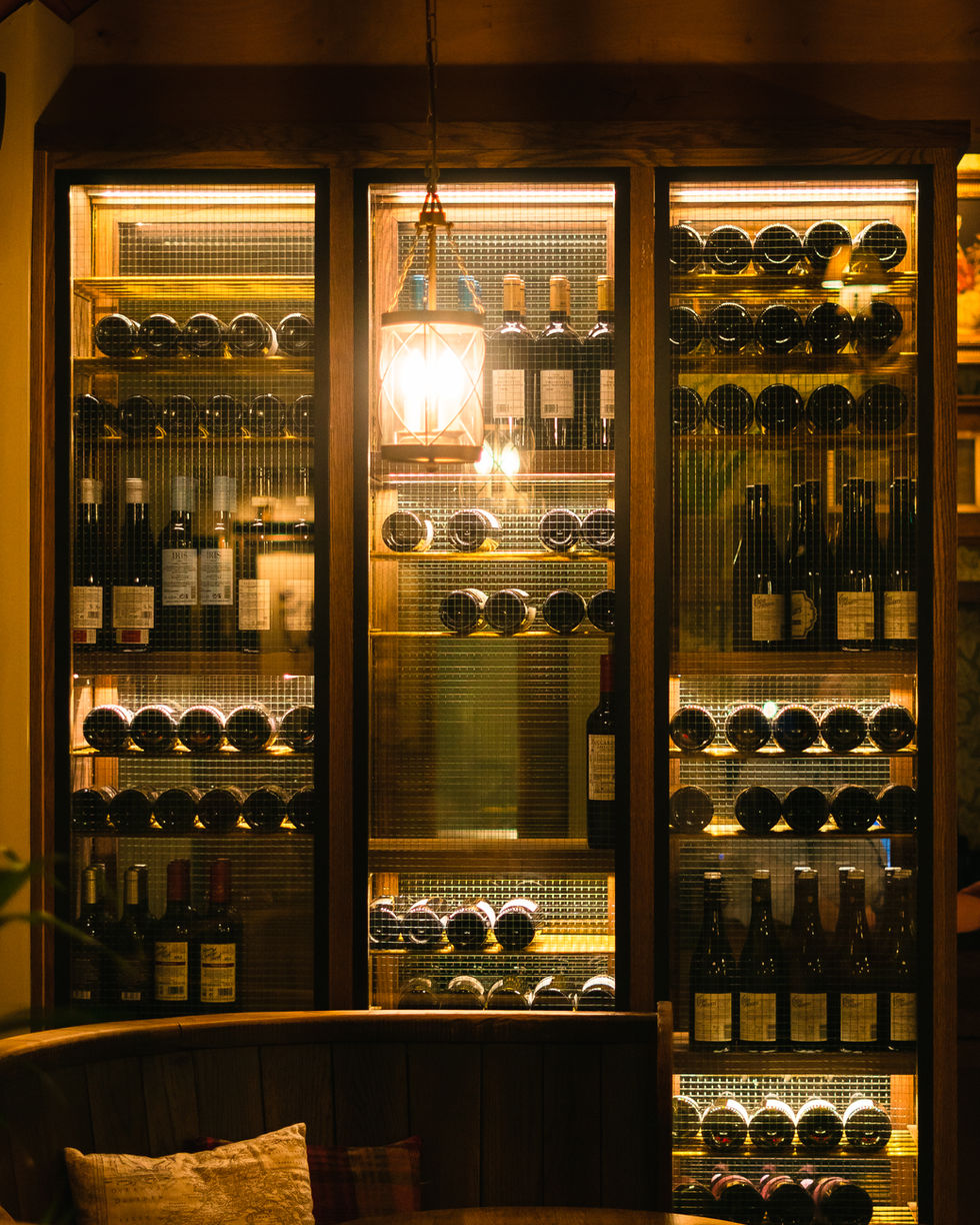 A wine rack with warm moody lighting, captured during a professional hospitality photography session in Chester by BeyondFram