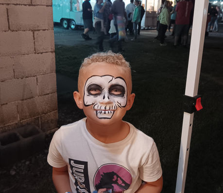 Boy at the fair with a skull face painting