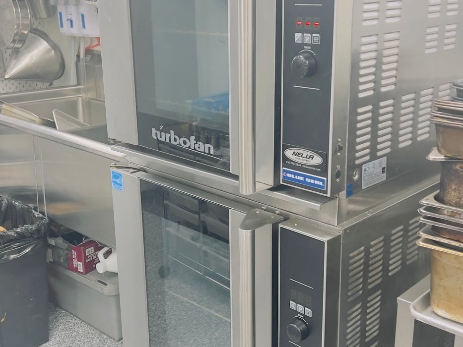 Commercial kitchen convection ovens with digital displays, stainless steel finish.