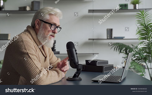 stock-photo-elderly-man-with-a-gray-beard-video-blogger-speaking-in-microphone-aged-broadc