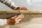 A man applying stucco to a wall