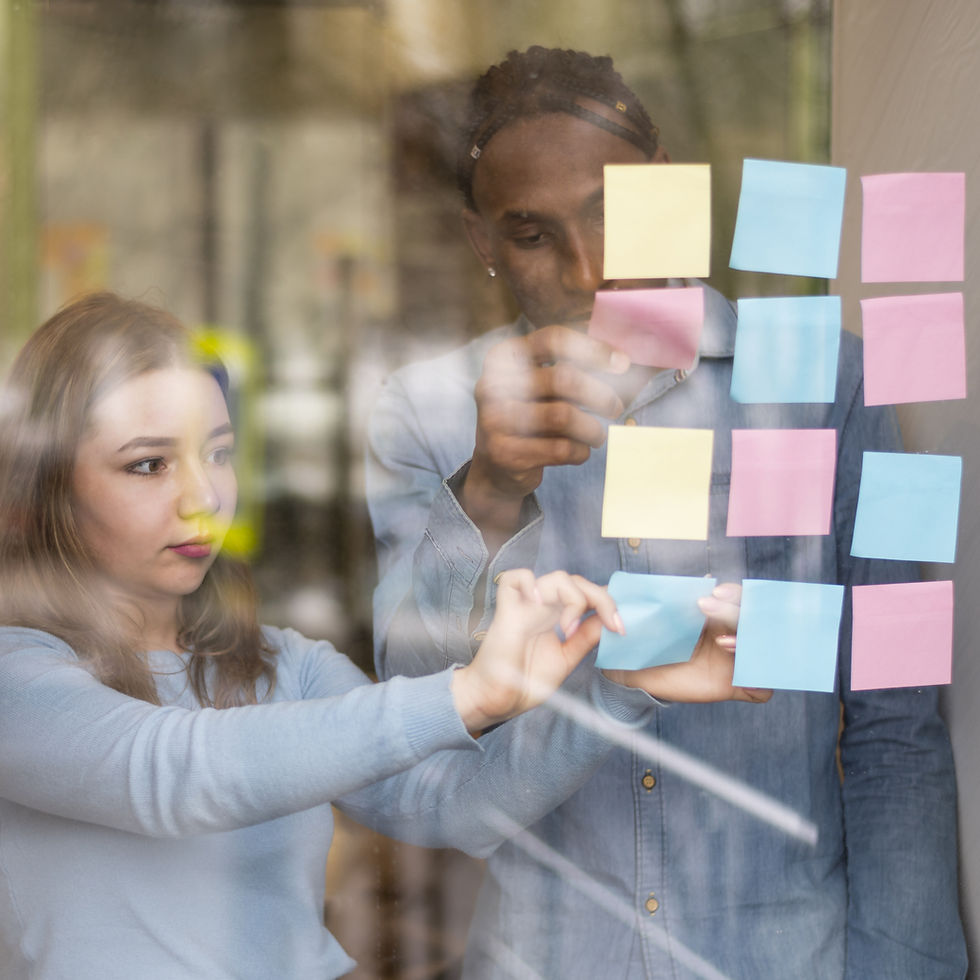 front-view-man-woman-putting-sticky-notes-office-window.jpg