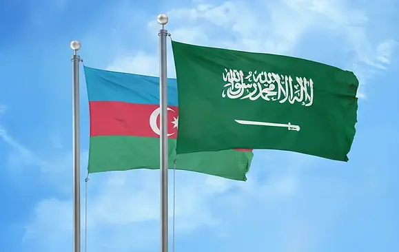 Azerbaijan Saudi Arabia and Azerbaijan flags flying together in the sky representing Saudi E-Tourist Visa for Azerbaijani citizens