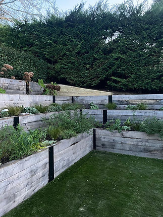 Bespoke planters with greenery on newly landscape garden