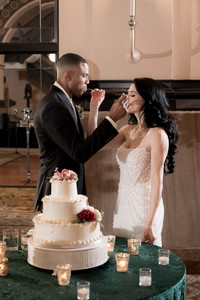 bride and groom feeding each other wedding cake